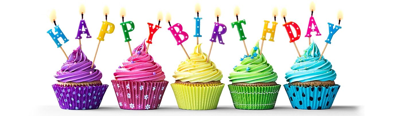 Row of colorful birthday cupcakes isolated on a white background